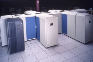 A 1995 IBM System/390 mainframe — a tall beige cabinet on wheels, the kind of machine that ran banks, payroll, and booking systems for decades
